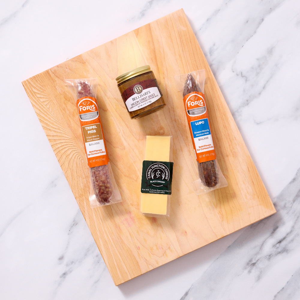 Beer Lovers Charcuterie Kit includes:

1 link of Lupo Salami
1 link of Tripel Pigs Salami
¼ lb. wedge Black Swamp Gouda cheese from Canal Junction Cheese
4 oz. jar Saigon Street Sauce from Bellisari's Gourmet Convenience