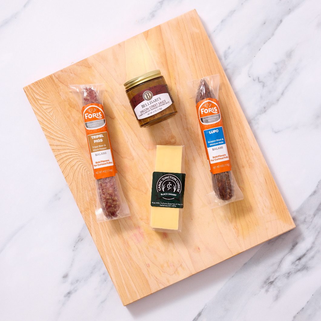 Beer Lovers Charcuterie Kit includes:

1 link of Lupo Salami
1 link of Tripel Pigs Salami
¼ lb. wedge Black Swamp Gouda cheese from Canal Junction Cheese
4 oz. jar Saigon Street Sauce from Bellisari's Gourmet Convenience