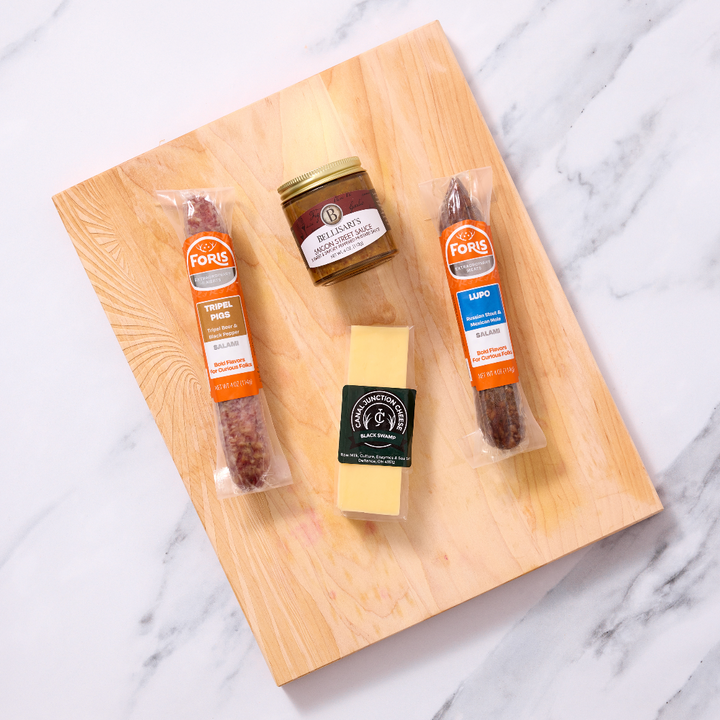 Beer Lovers Charcuterie Kit includes:

1 link of Lupo Salami
1 link of Tripel Pigs Salami
¼ lb. wedge Black Swamp Gouda cheese from Canal Junction Cheese
4 oz. jar Saigon Street Sauce from Bellisari's Gourmet Convenience
