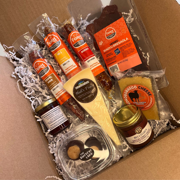 Foris Meats Buckeye Charcuterie Collection with gourmet salamis and bresaola, locally sourced cheese, mustard, and jam, along with Ohio made buckeyes.