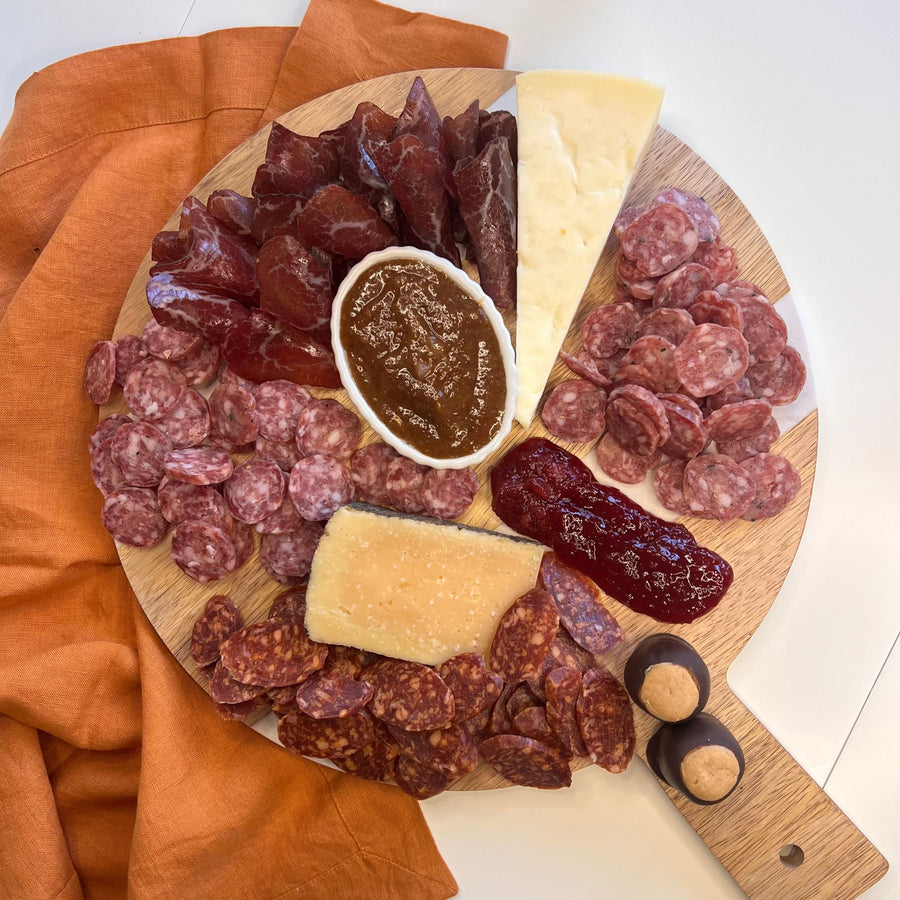 Foris Meats Buckeye Charcuterie Collection with gourmet salamis and bresaola, locally sourced cheese, mustard, and jam, along with Ohio made buckeyes.